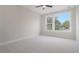 Cozy bedroom featuring a ceiling fan, large window, and neutral carpet at 319 Crossing Ct., Myrtle Beach, SC 29588