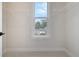 Empty walk-in closet with carpet and adjustable white wire shelving and a window overlooking a neighboring home at 319 Crossing Ct., Myrtle Beach, SC 29588