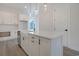 Bright kitchen showcasing a farmhouse sink, white cabinetry, and stylish pendant lighting at 319 Crossing Ct., Myrtle Beach, SC 29588