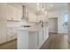 Modern kitchen with white cabinets, stainless steel appliances, and an island with a sink at 319 Crossing Ct., Myrtle Beach, SC 29588