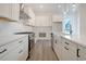 Modern kitchen with white cabinets, stainless steel appliances, and quartz countertops at 319 Crossing Ct., Myrtle Beach, SC 29588