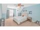 Light blue bedroom featuring a bed, chair swing, shelving, and other decor at 359 Rose Ave., Georgetown, SC 29440