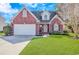 Charming brick home featuring a well-manicured lawn, attached two-car garage, and classic architectural details at 359 Rose Ave., Georgetown, SC 29440