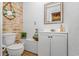 Coastal half bathroom with wood-look accents, vanity and wooden framed mirror at 359 Rose Ave., Georgetown, SC 29440