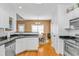 Open concept kitchen with white cabinets, stainless appliances, and an adjacent dining area at 359 Rose Ave., Georgetown, SC 29440