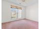 Empty bedroom has a ceiling fan, carpet, and a window with natural light at 1501 Hallborough Dr., Surfside Beach, SC 29575