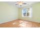 Bright bedroom features a ceiling fan, window with natural light, and hardwood floors at 1501 Hallborough Dr., Surfside Beach, SC 29575