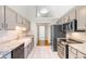 Modern kitchen with stainless steel appliances, granite counters, and farmhouse sink, perfect for cooking at 1501 Hallborough Dr., Surfside Beach, SC 29575