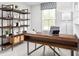 Modern home office with a large wooden desk, shelving unit, and natural light from the window at 371 Myrtle Meadows Dr # 417B, Conway, SC 29526