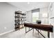 Modern home office with a large wooden desk, shelving unit, and natural light from the window at 371 Myrtle Meadows Dr # 417B, Conway, SC 29526