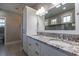 Elegant bathroom featuring a double sink vanity with granite countertops, a large mirror, and ample storage space at 377 Waties Dr., Murrells Inlet, SC 29576