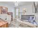 Bright home office featuring a modern desk setup, chandelier, and stylish decor at 377 Waties Dr., Murrells Inlet, SC 29576