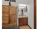 Bathroom with wood cabinets, a vessel sink, and a mirror showing the bedroom window at 401 10Th Ave. S # C-3, Myrtle Beach, SC 29577