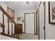 Inviting hallway with staircase, tile flooring, and decorative artwork at 401 10Th Ave. S # C-3, Myrtle Beach, SC 29577