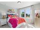 Bright bedroom with a large window, vibrant bedding, and decorative accents at 4019 Bucolic Loop, Myrtle Beach, SC 29588