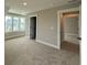 Bright bedroom with plush carpeting, large windows, and ensuite bathroom at 4019 Bucolic Loop, Myrtle Beach, SC 29588
