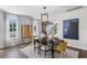 Modern dining room featuring a stylish light fixture, sleek furniture, and plenty of natural light at 4019 Bucolic Loop, Myrtle Beach, SC 29588