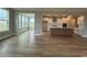 Open floor plan featuring a spacious living room, modern kitchen, and stunning hardwood floors at 4019 Bucolic Loop, Myrtle Beach, SC 29588