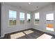 Sun-drenched living room with plank floors, large windows, and a view of the backyard at 4019 Bucolic Loop, Myrtle Beach, SC 29588