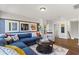 Cozy living room featuring a comfortable blue sofa, decorative artwork, and a round coffee table on a patterned rug at 4019 Bucolic Loop, Myrtle Beach, SC 29588