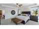 Serene main bedroom featuring a large bed, a leather bench, modern décor and bright windows at 4019 Bucolic Loop, Myrtle Beach, SC 29588