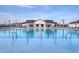 Community pool with palm trees, lounge chairs, and a clubhouse in the background at 4019 Bucolic Loop, Myrtle Beach, SC 29588