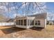 View of a house's backyard with a screened porch and a small deck at 4030 Manor Wood Dr., Myrtle Beach, SC 29588