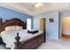 Bright bedroom with a dark wood sleigh bed, blue walls, and view into the en suite bath at 4030 Manor Wood Dr., Myrtle Beach, SC 29588