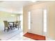 Bright foyer with tile flooring, complemented by the adjacent dining area with chandelier at 4030 Manor Wood Dr., Myrtle Beach, SC 29588