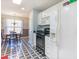 Open kitchen showcasing black appliances, white cabinets and unique black and white patterned flooring at 4030 Manor Wood Dr., Myrtle Beach, SC 29588