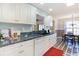 Bright kitchen features white cabinets, neutral countertops, and a view into the breakfast nook at 4030 Manor Wood Dr., Myrtle Beach, SC 29588