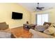 Inviting living room featuring wood floors, a large TV, and comfortable seating arrangements at 4030 Manor Wood Dr., Myrtle Beach, SC 29588