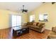 Comfortable living room with vaulted ceilings, ceiling fan, and sliding glass doors for natural light at 4030 Manor Wood Dr., Myrtle Beach, SC 29588