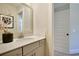 Bright bathroom with a modern vanity, framed mirror, minimalist decor, and a view into an adjacent room at 4060 Bucolic Loop, Myrtle Beach, SC 29588