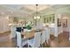 Open-concept dining area with a view of the kitchen featuring coffered ceilings and modern lighting at 4060 Bucolic Loop, Myrtle Beach, SC 29588