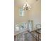 Bright two-story foyer with decorative chandelier, lots of windows, a staircase and view of the front door at 4060 Bucolic Loop, Myrtle Beach, SC 29588