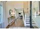 Inviting foyer featuring hardwood floors, staircase, a console table with lamps, and seamless transition to the living spaces at 4060 Bucolic Loop, Myrtle Beach, SC 29588