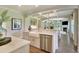 Bright kitchen features stainless steel appliances, farmhouse sink, and an open design flowing into the living area at 4060 Bucolic Loop, Myrtle Beach, SC 29588