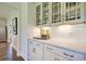 Elegant bar area with white cabinets, granite countertops, subway tile backsplash, and decorative glass shelving at 4060 Bucolic Loop, Myrtle Beach, SC 29588