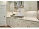 This kitchen includes custom cabinets, stainless steel vent hood, gas cooktop, and white subway tile backsplash at 4060 Bucolic Loop, Myrtle Beach, SC 29588