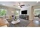 Cozy living room with hardwood floors, an area rug, natural light, and a view into a separate living area at 4060 Bucolic Loop, Myrtle Beach, SC 29588