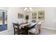 Bright dining room with a dark wood table, upholstered chairs, and a large window at 418 Clear Lake Dr., Conway, SC 29526