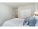 Spacious bedroom with ensuite bathroom and walk-in closet with blue bedding and white doors at 419 Clear Lake Dr., Conway, SC 29526