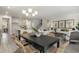 Open concept dining room features modern black table with seating for six, flowing to living and kitchen spaces at 426 Clear Lake Dr., Conway, SC 29526