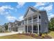 View of multiple two-story homes with covered porches and lovely landscaping at 426 Clear Lake Dr., Conway, SC 29526