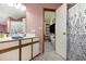 Retro bathroom, with pink wallpaper, wood trim, and doorway leading to bedroom at 4497 Little River Inn Ln. # 1507, Little River, SC 29566