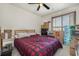 Functional bedroom with a cozy red and black comforter, complemented by natural light at 4497 Little River Inn Ln. # 1507, Little River, SC 29566