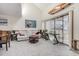 Bright living room with neutral carpet, complemented by a white sofa and a surfboard on the wall at 4497 Little River Inn Ln. # 1507, Little River, SC 29566