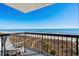 Balcony view of the beach, dunes, and ocean with outdoor seating and a sunny, private spot to relax and unwind at 4619 S Ocean Blvd. # 501, North Myrtle Beach, SC 29582