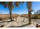 Picturesque beach path through dunes with rope railing, leading to the ocean, framed by palms and clear skies at 4619 S Ocean Blvd. # 501, North Myrtle Beach, SC 29582